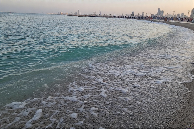 Calm waves and beachfront promenade at Abu Dhabi Corniche Beach